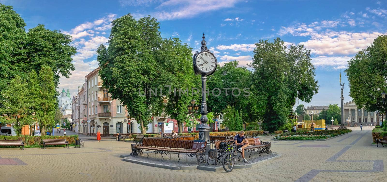 Ternopil, Ukraine 06.07.2021. Tripartite clock  on the Taras Shevchenko Boulevard in Ternopil, Ukraine, on a sunny summer morning