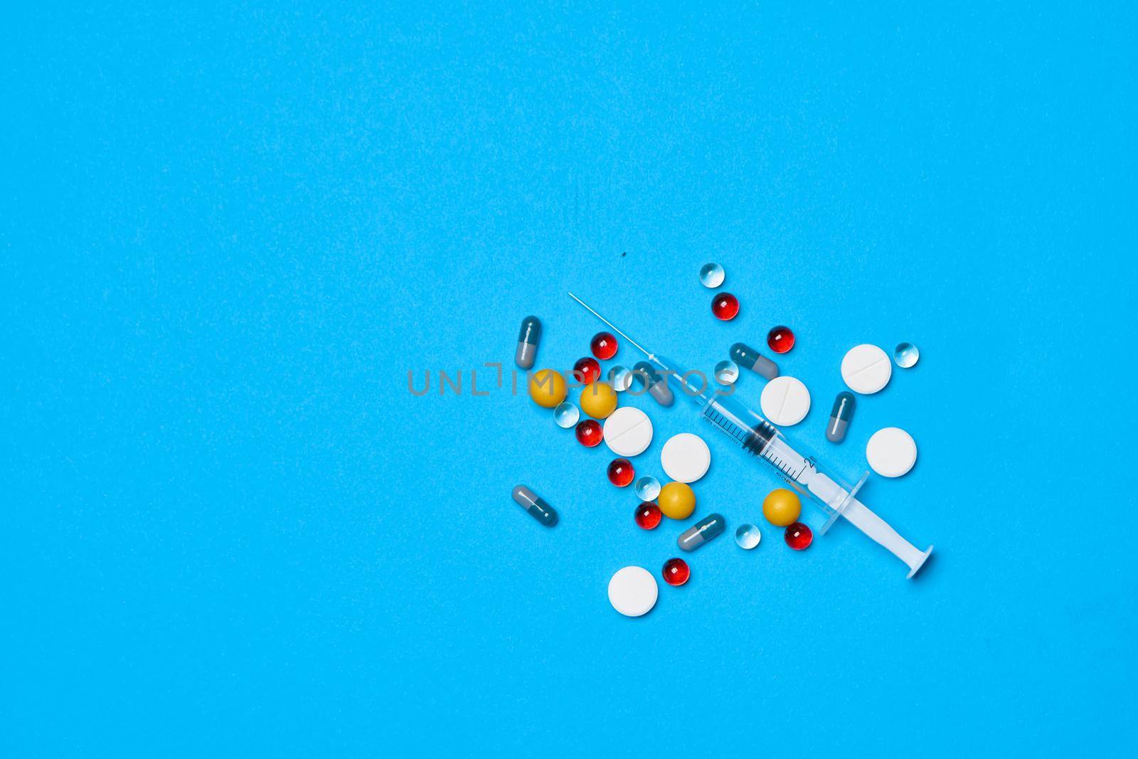 medicine jar vitamins capsules medicine blue background. High quality photo