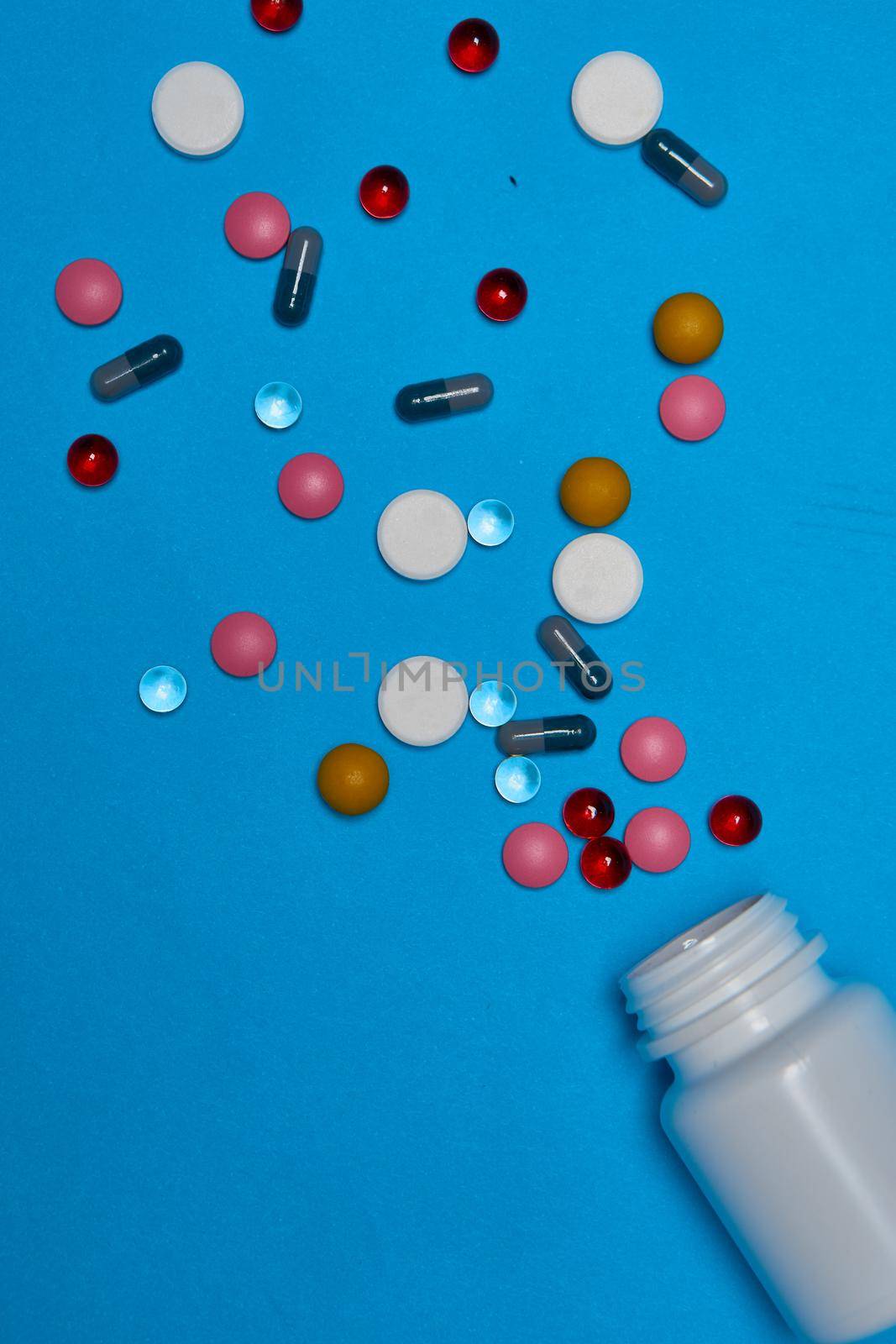 medicine jar vitamins capsules medicine blue background. High quality photo