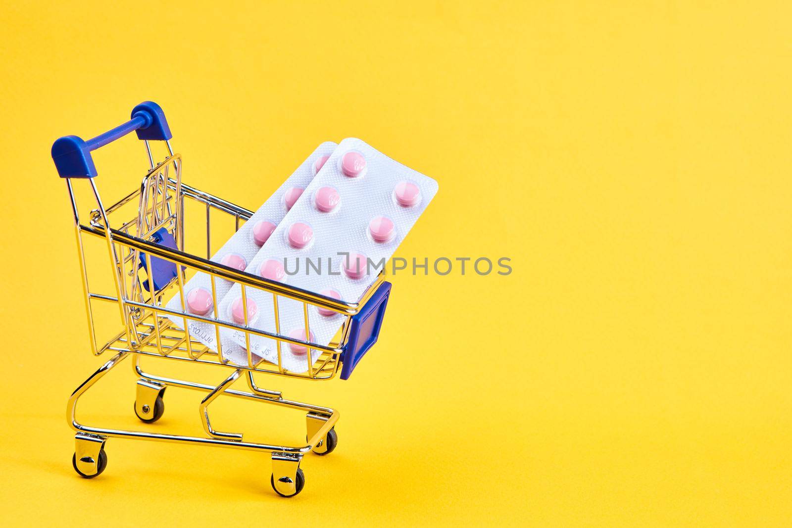 drug trolleys service delivery shopping pharmacy yellow background. High quality photo