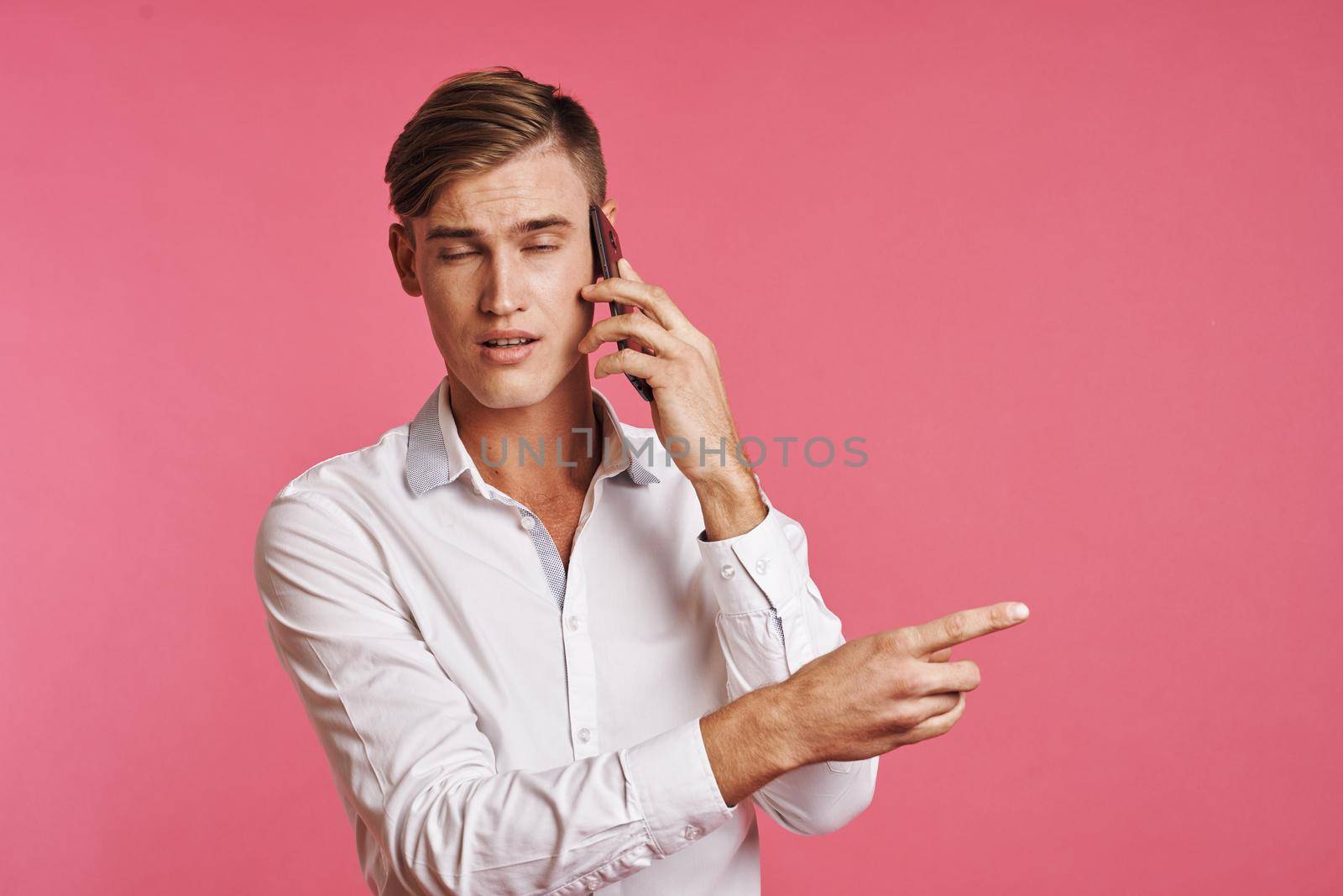 handsome man technology communication emotions pink background by Vichizh