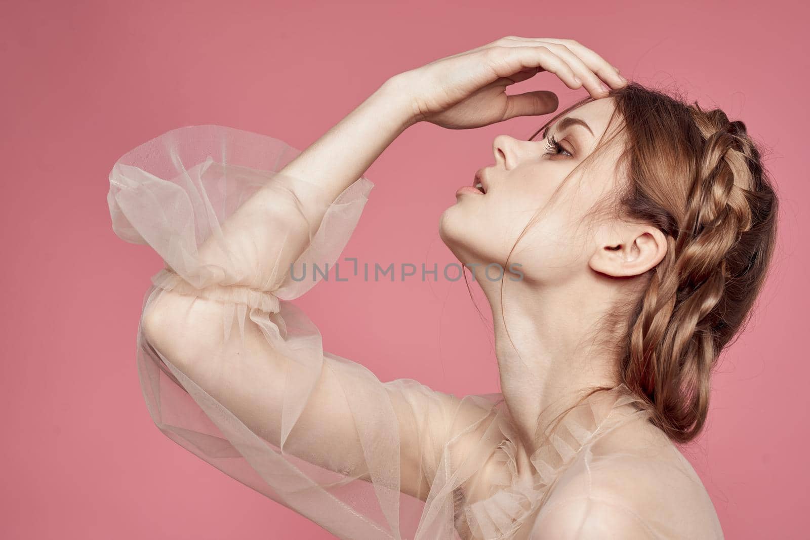 pretty woman gesture hands cosmetics fashion hairstyle posing pink background. High quality photo