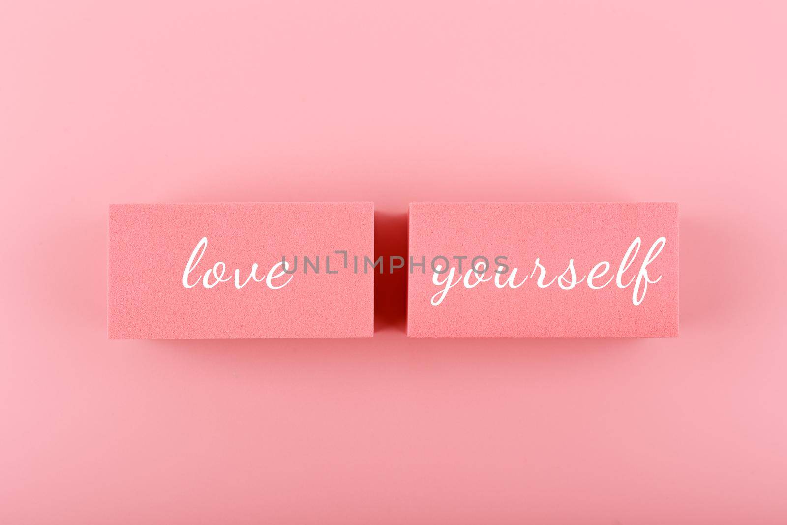 Self love and mental health minimal creative concept in pink colors against pink background. Text on pink background by Senorina_Irina