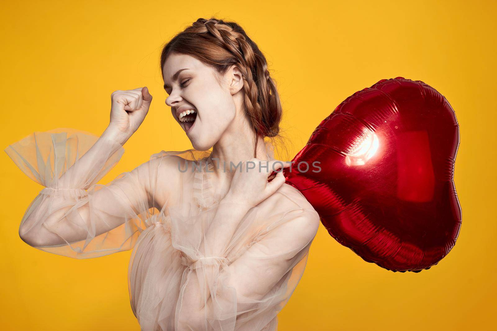 cheerful woman heart balloon holiday Valentine's Day yellow background by Vichizh