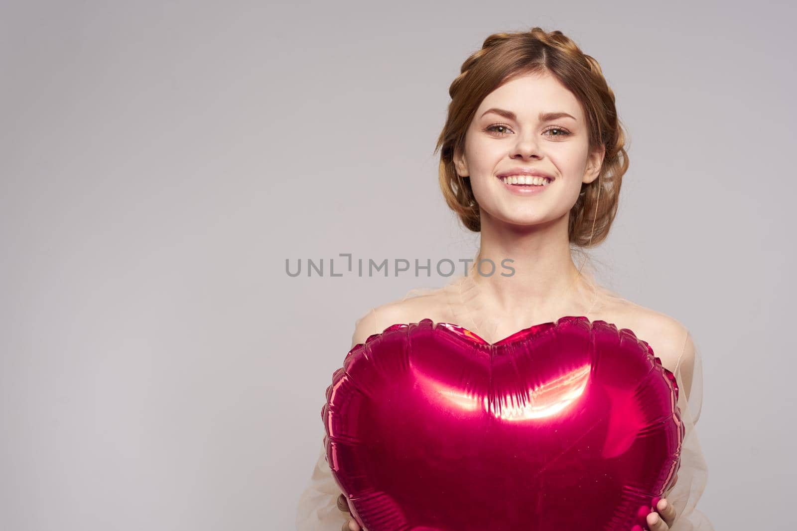 pretty woman red heart in the hands of the balloon isolated background. High quality photo