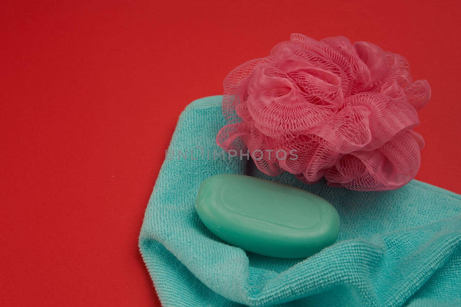 soap bath supplies hygiene body care red background. High quality photo