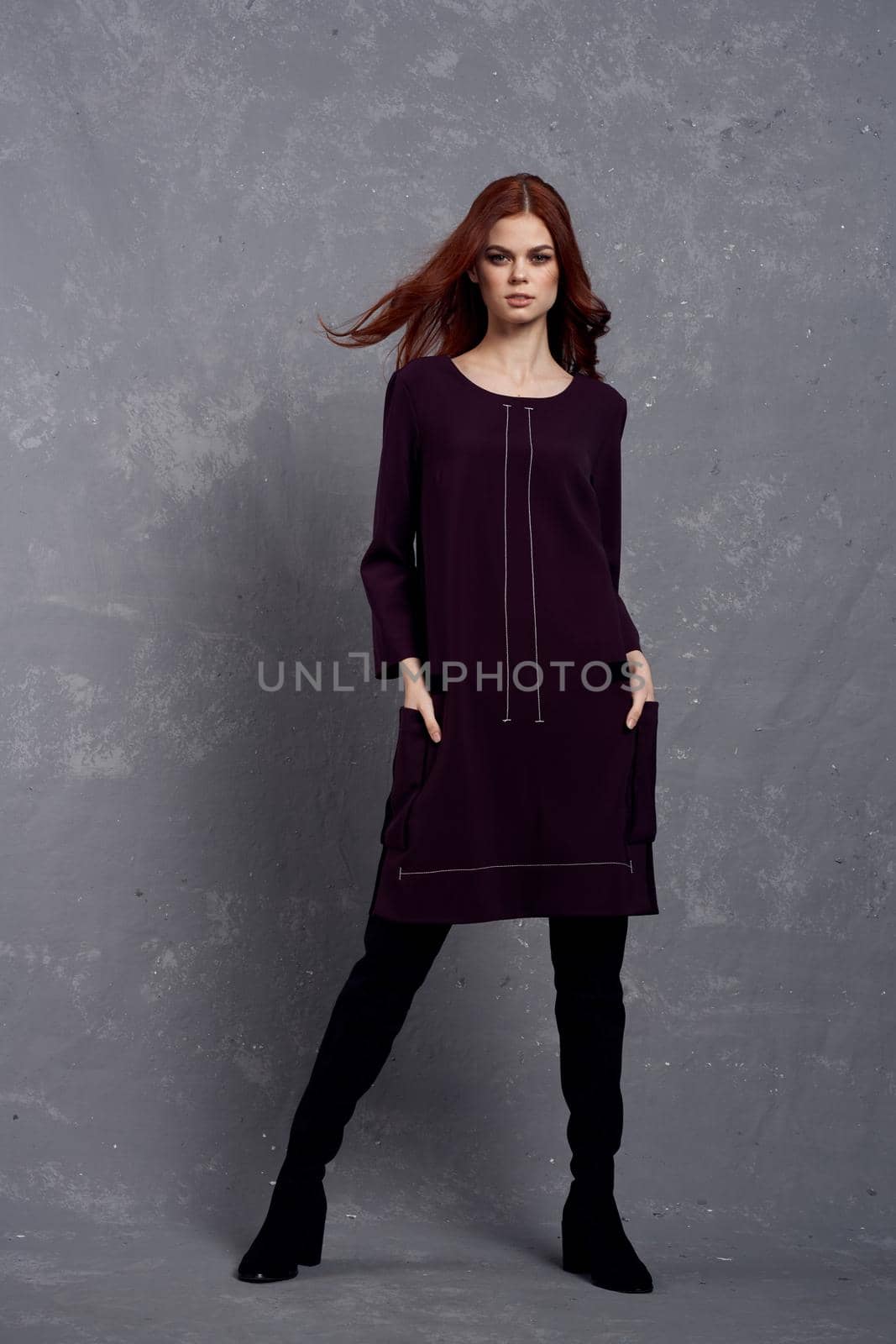 woman in fashionable clothes in full length posing in studio glamor. High quality photo