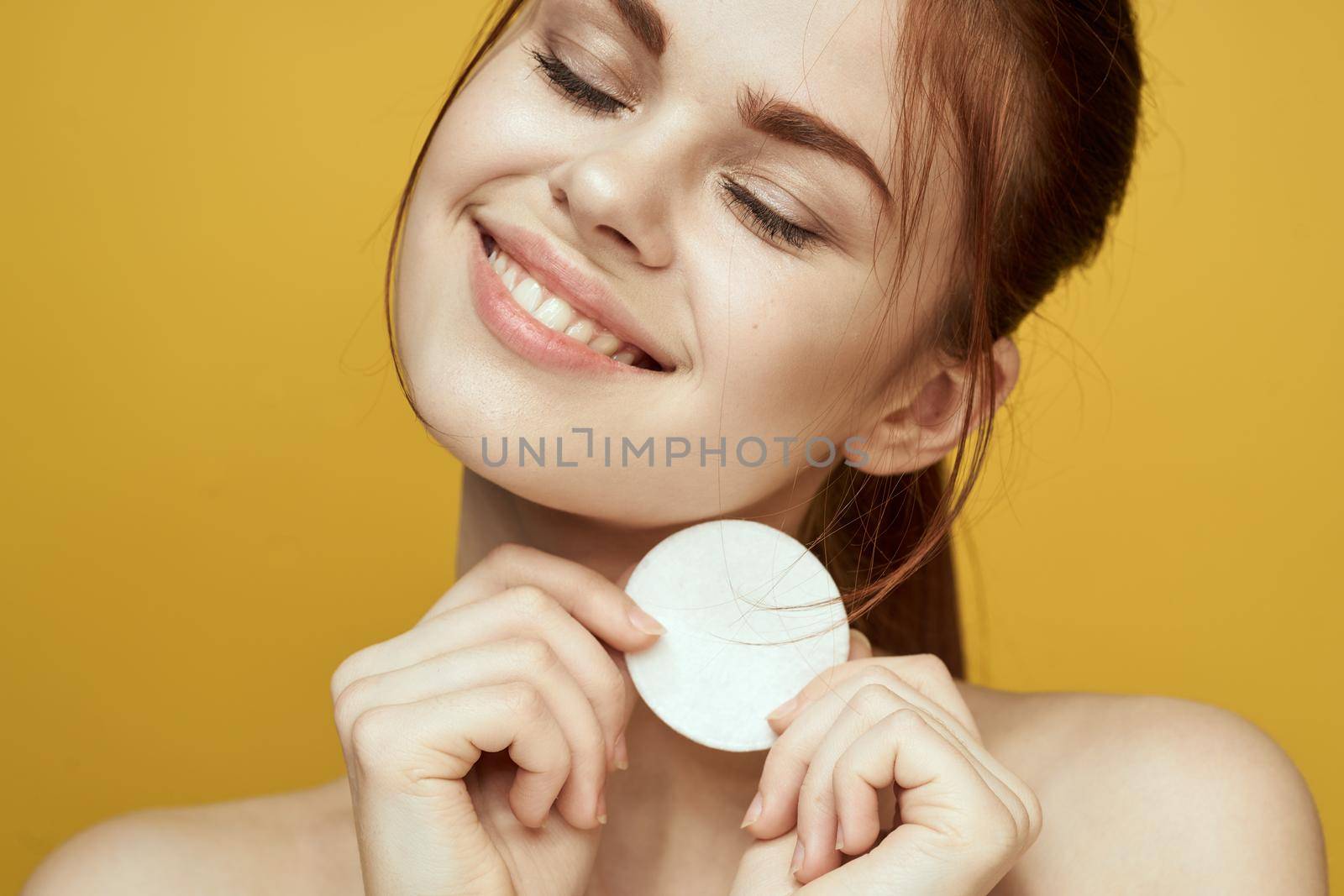 emotional women bare shoulders cotton pads and clear skin attractive look. High quality photo