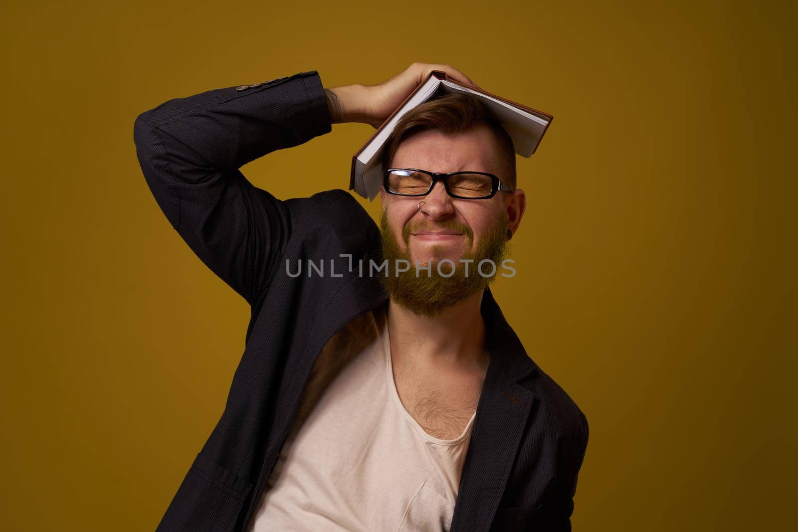 bearded man in a black jacket with a book in his hands education. High quality photo