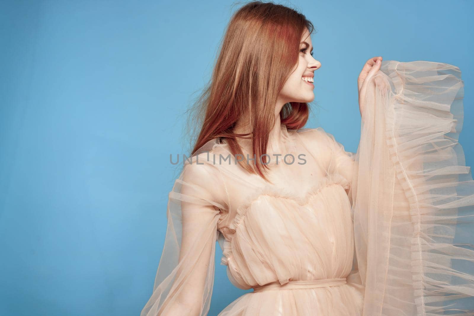 beautiful woman hairstyle fun posing cosmetics fashion blue background. High quality photo