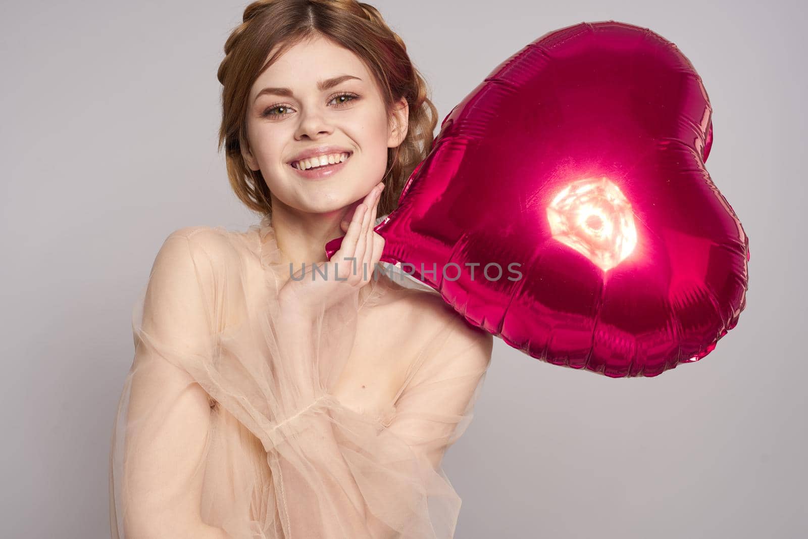 portrait of a woman red heart in the hands of the balloon isolated background. High quality photo