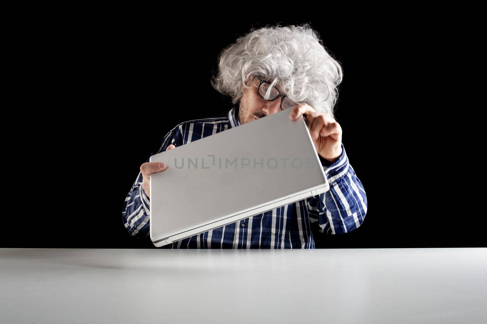 An elderly man does not know how to use the computer. by bepsimage