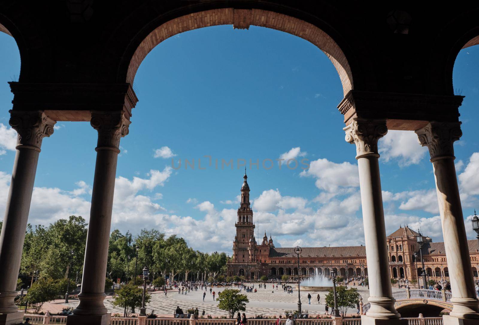 view of Seville's main square Plaza de Espana from arch covered walkway Spain by Sandronize