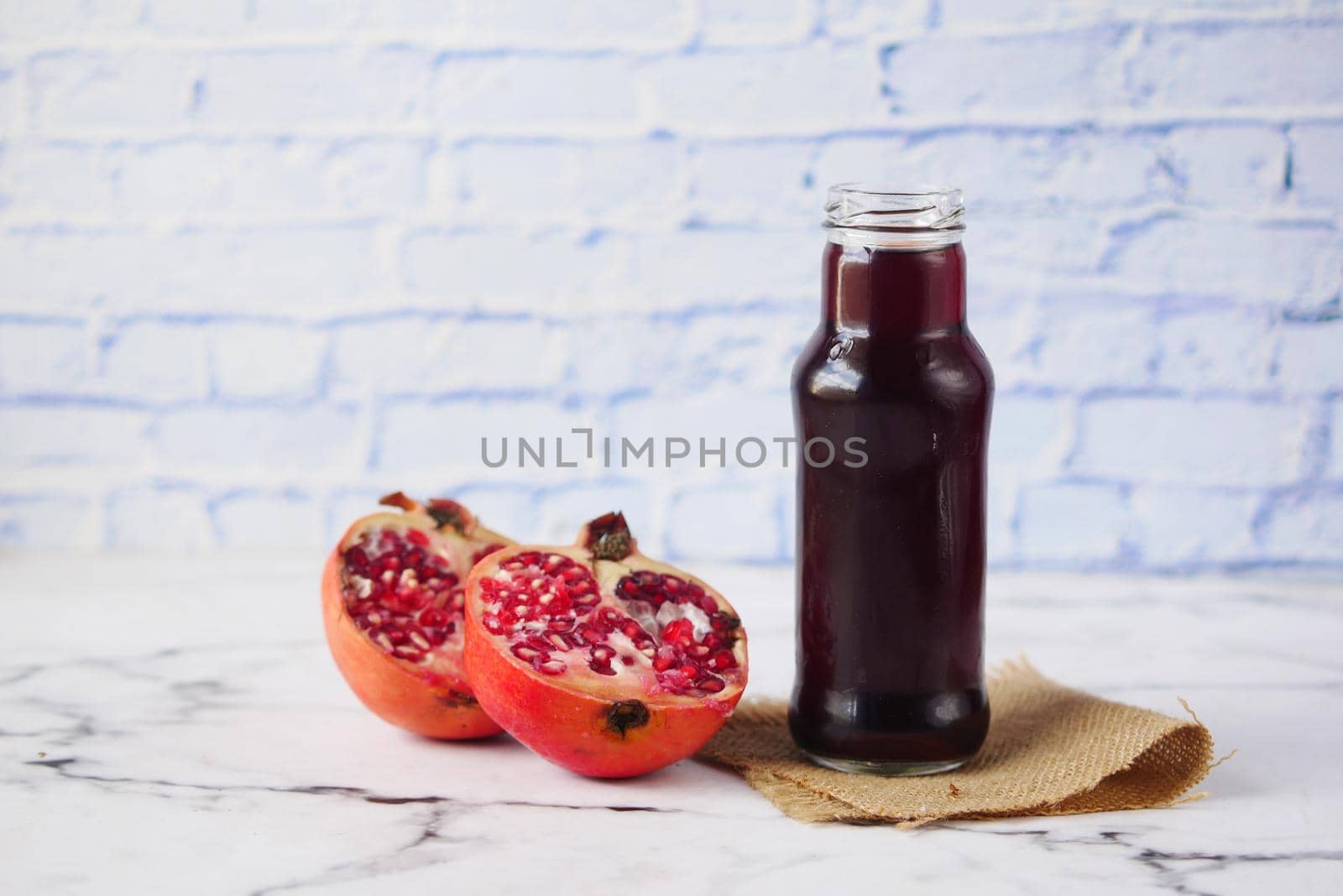 glass on pomegranate juice on table with copy space ,