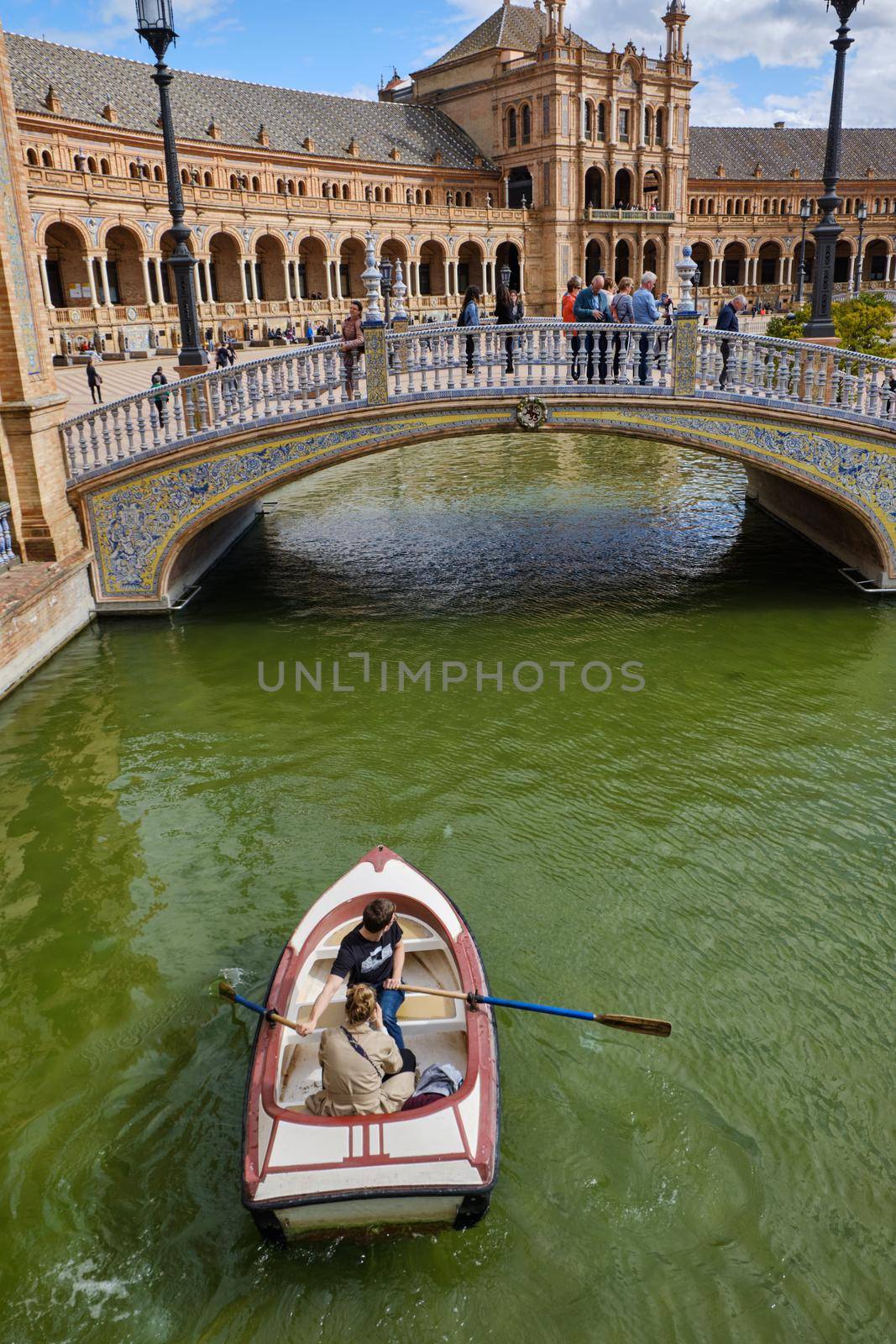 April 2019 - lovers on the little boat and bridge of Andalisia Seville's main square Plaza de Espana by Sandronize
