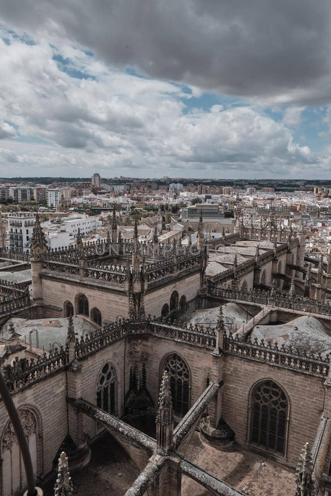 Aerial view of the Cathedral of Saint Mary of the See (Seville Cathedral) in Seville, Andalusia, Spain in a sunny and cloudy day. by Sandronize