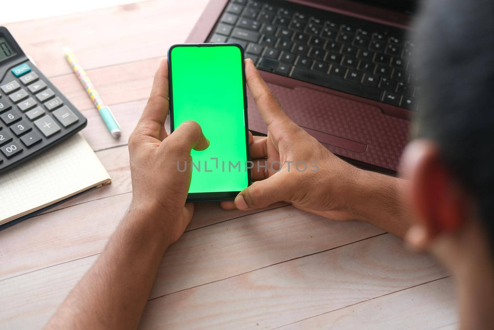 top view of man hand using smart phone on office desk by towfiq007