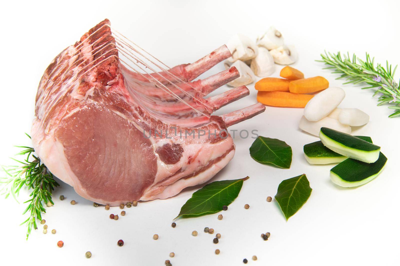 Pork ribs, Pork ribs with raw bone, Entrecote, Fresh and raw meats. Organic food, Meat with spices: pepper, salt, bay leaf, rosemary and its vegetables. High quality photo