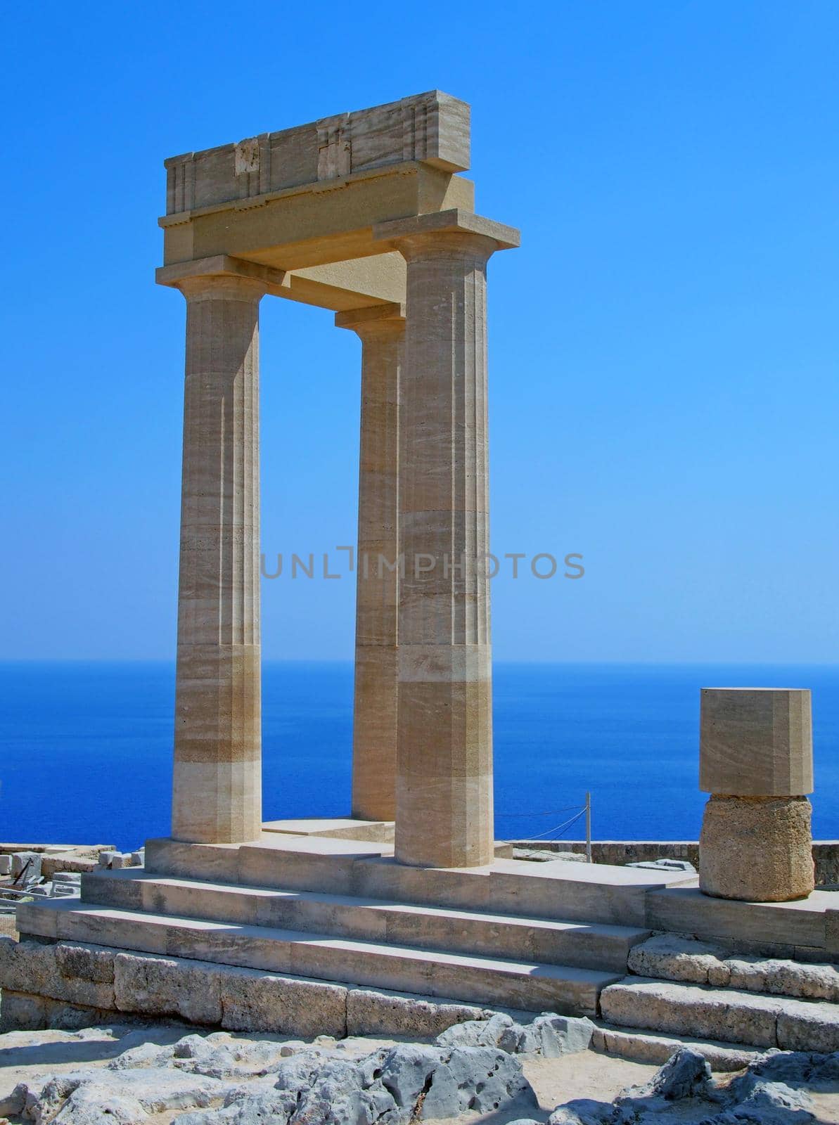 the acropolis in lindos rhodes with blue sky and sea in summer  by philopenshaw