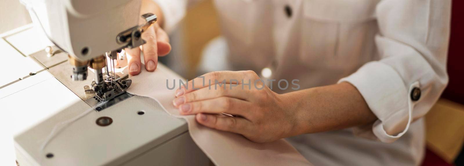 close up woman working with sewing machine. High resolution photo