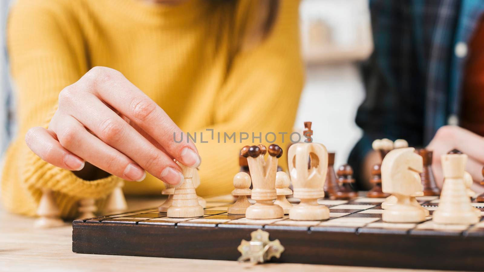 close up young woman playing chess board game. High quality photo by Zahard