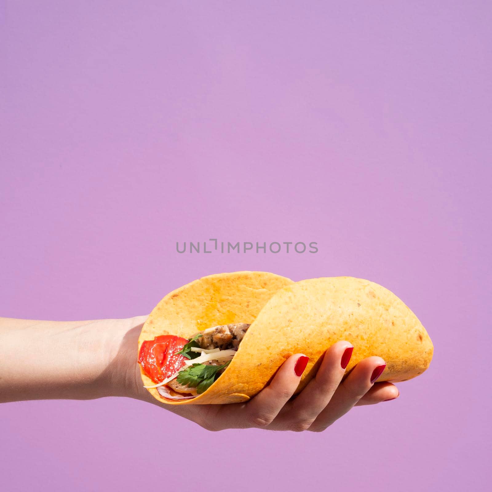 close up woman with burrito purple background. High quality photo by Zahard