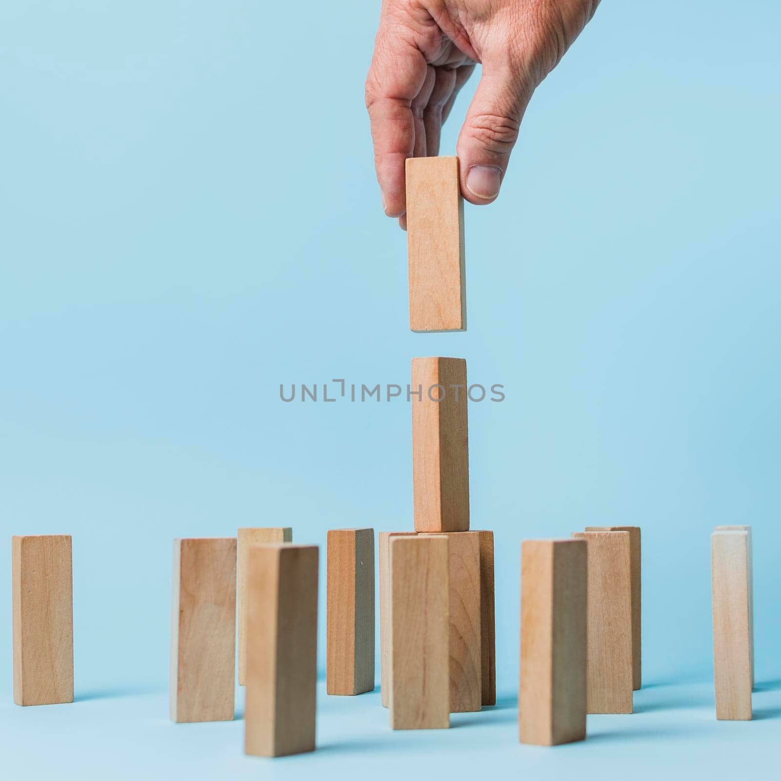 businessman using wooden pieces. High quality photo by Zahard