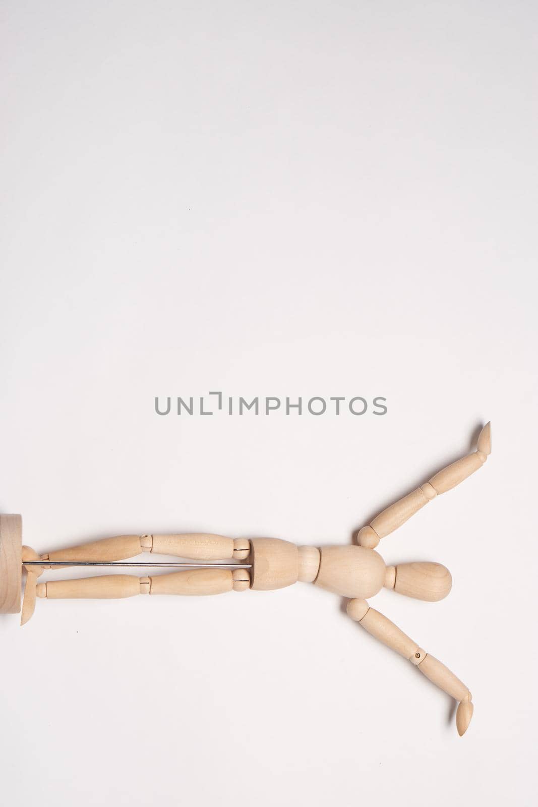 wooden man mannequin posing object light background. High quality photo