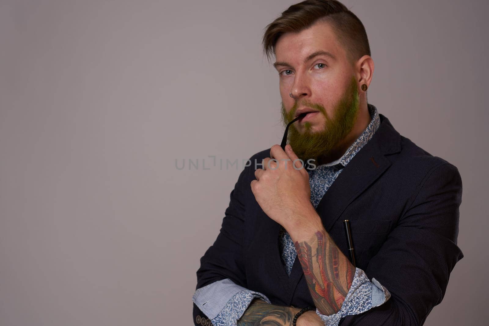 business man with glasses with tattoos on his arms office professionals. High quality photo