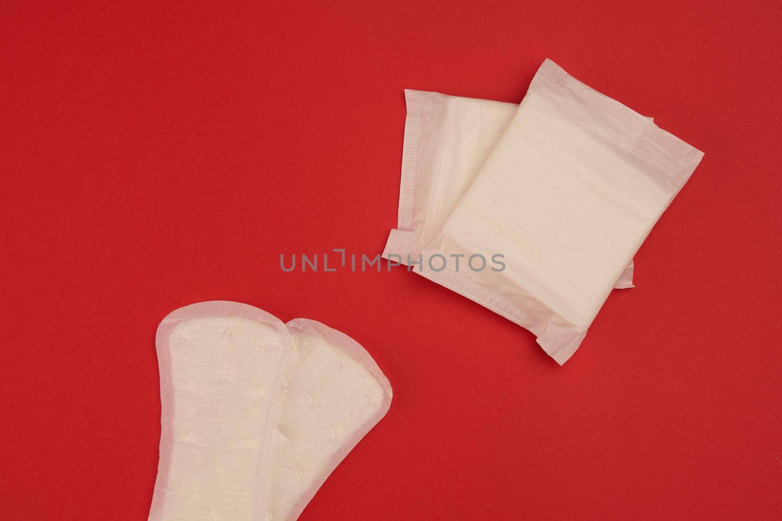 pads tampons underwear feminine hygiene red background. High quality photo