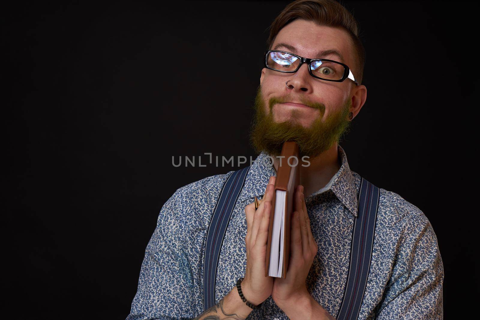 man in glasses with a notebook in his hands training professional office by Vichizh