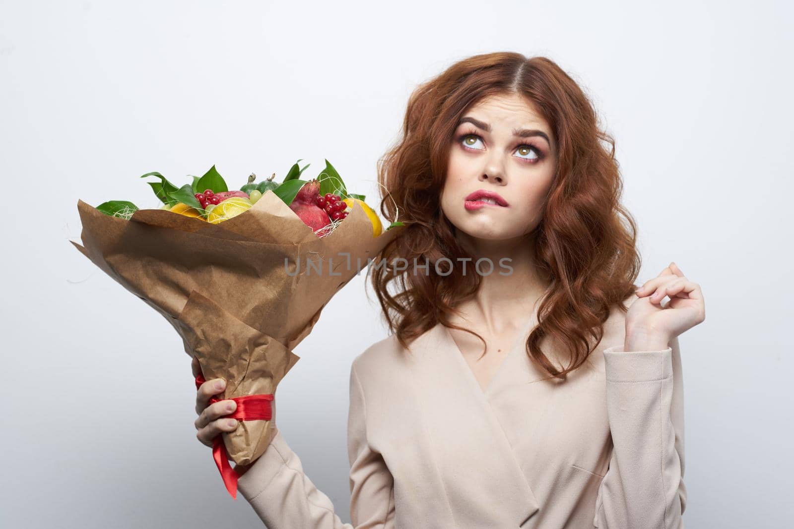 pretty woman bright makeup attractive look a bouquet of fruits light background by Vichizh