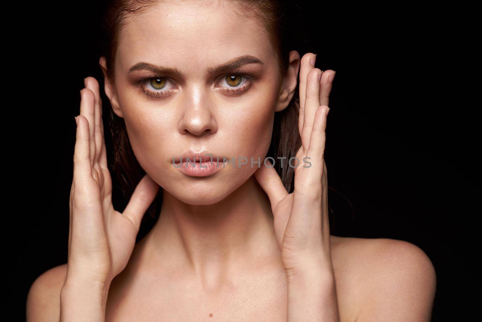 portrait of a woman bare shoulders clean skin wet hair dark background by Vichizh