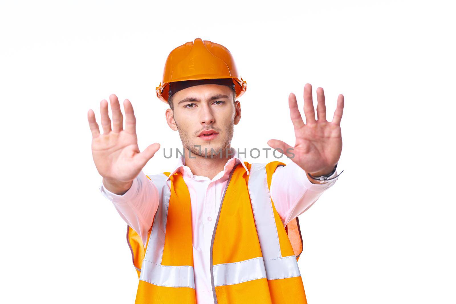 working man in orange uniform posing construction. High quality photo