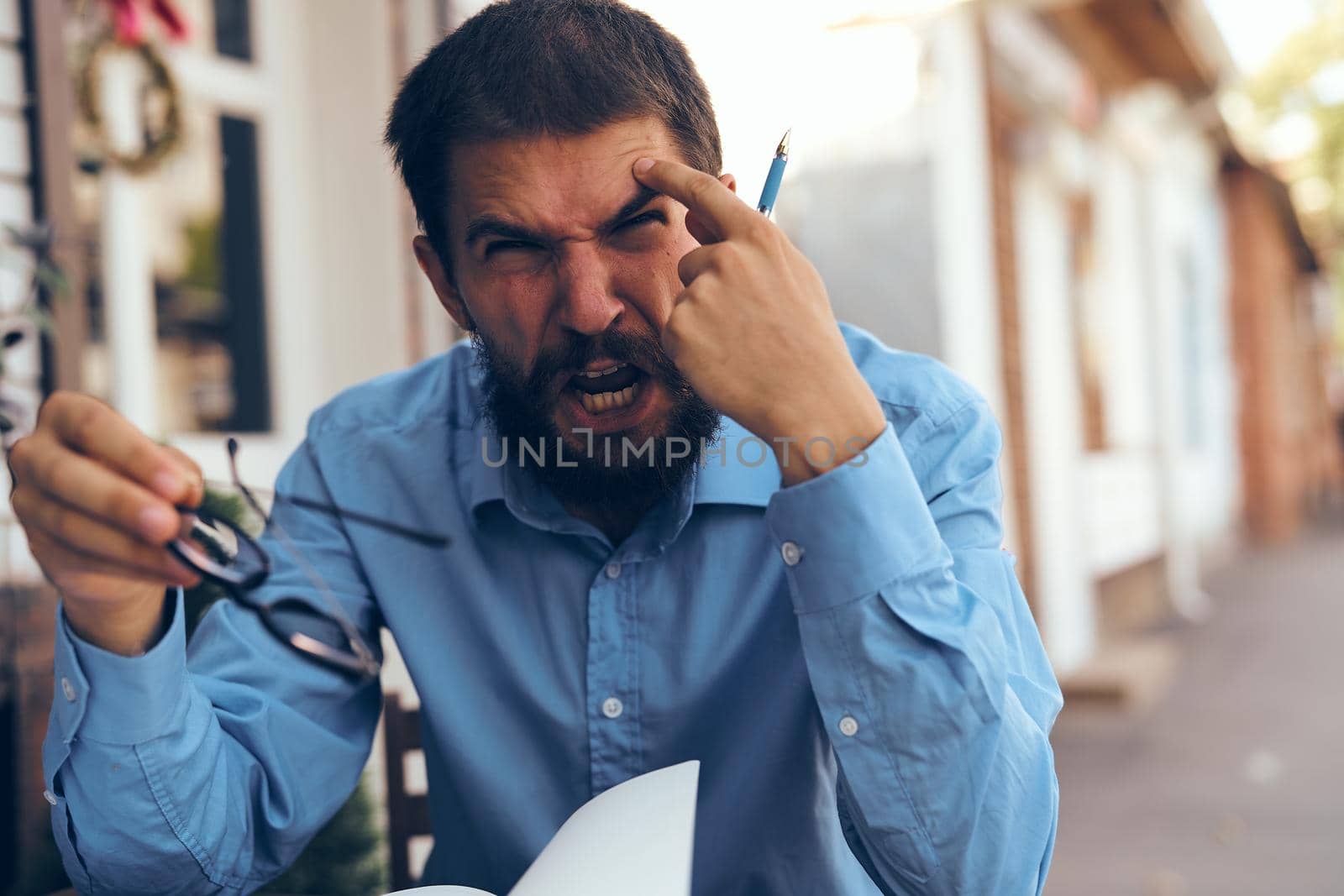 business man in blue shirt in cafe work paperwork by Vichizh