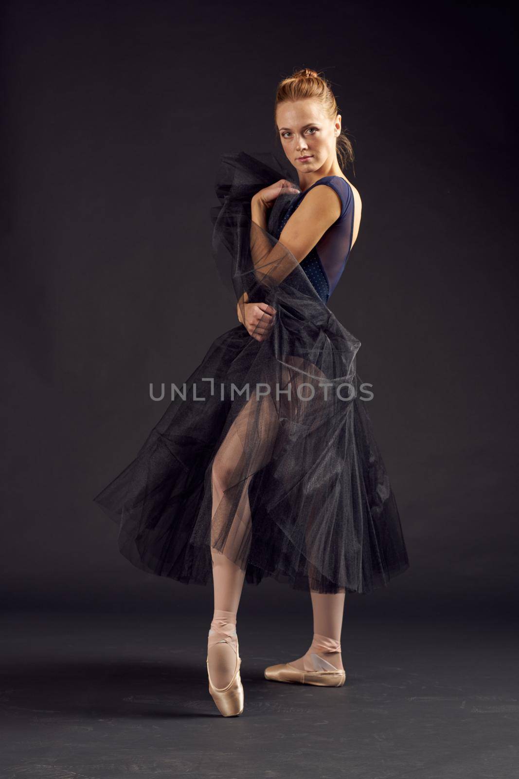 woman dancer elegant style art balance artist dark background. High quality photo