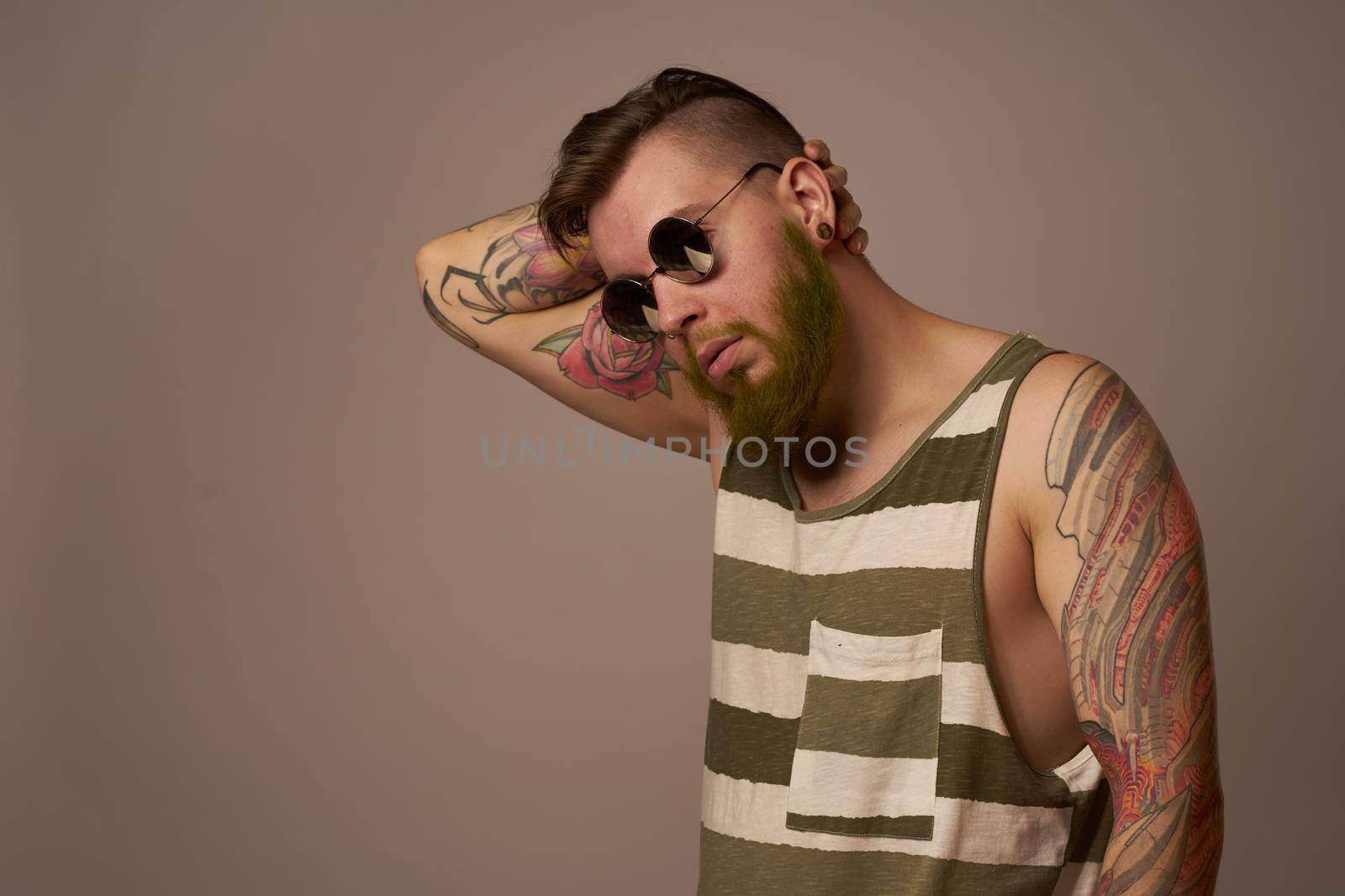 bearded man in striped t-shirt glasses tattoo on his arms fashion by Vichizh