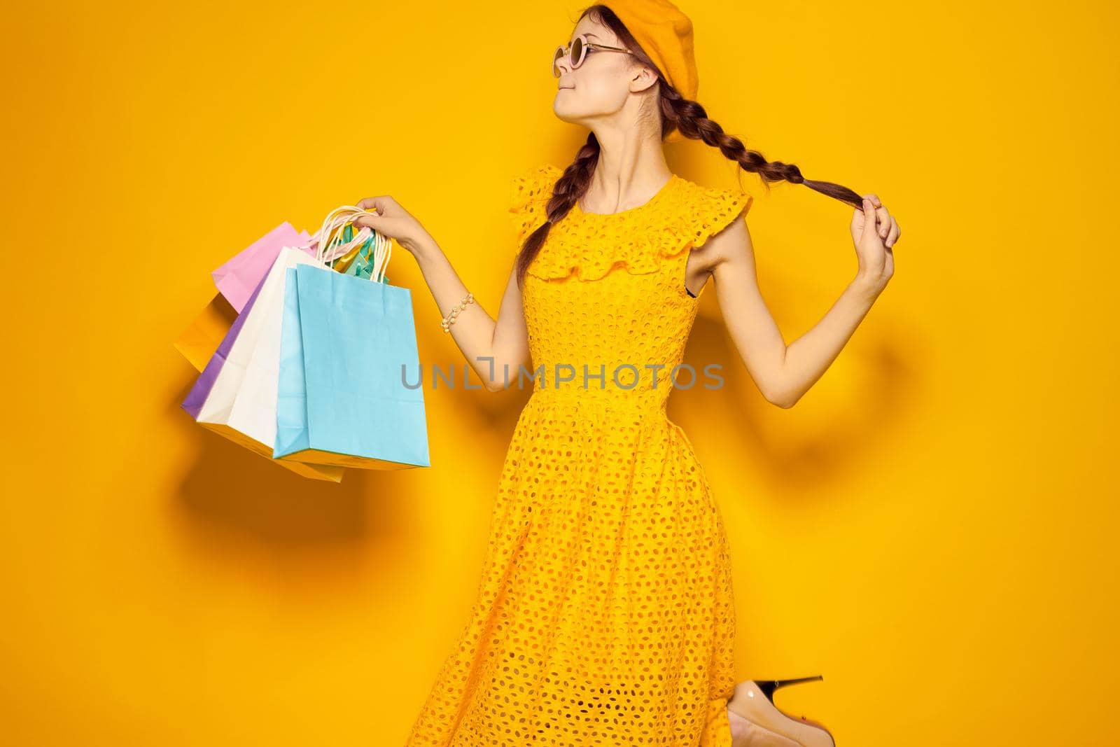 smiling woman with multicolored bags posing isolated background by Vichizh