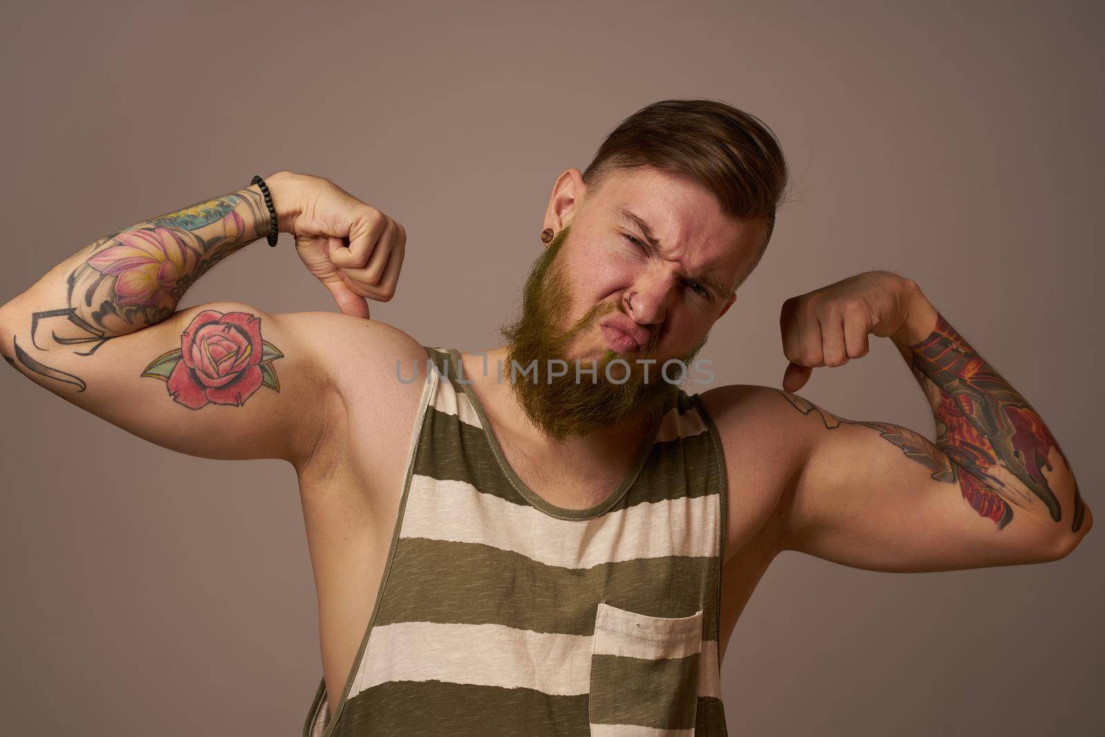 handsome man with tattoos on his arms fashionable hairstyle emotions by Vichizh