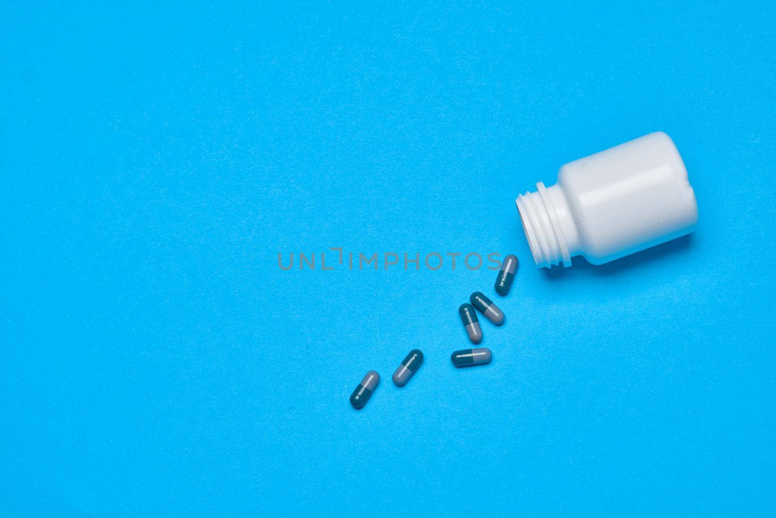 multicolored pills treatment health care blue background. High quality photo