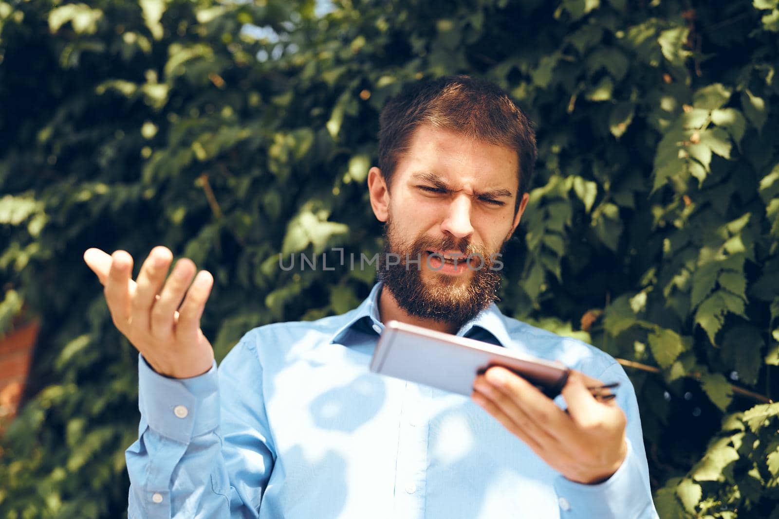 emotional man talking on the phone in the street. High quality photo