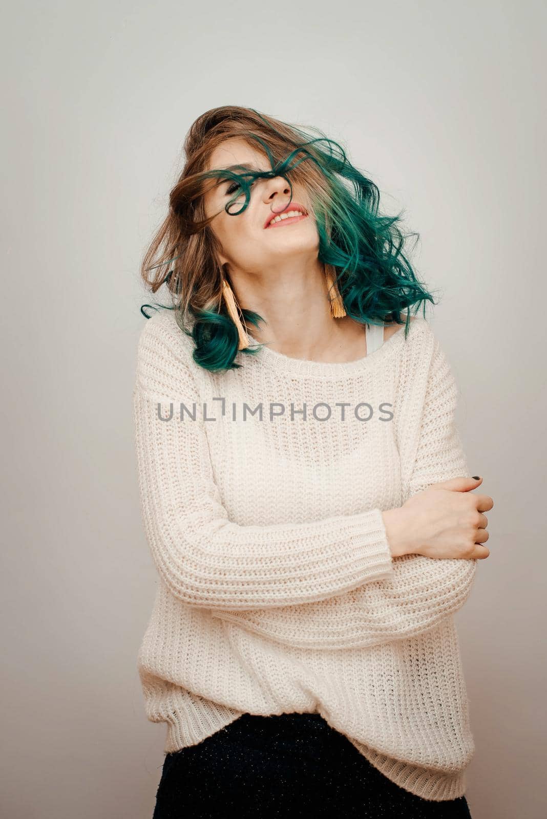 Happy woman with colored hair on a white background. by RecCameraStock