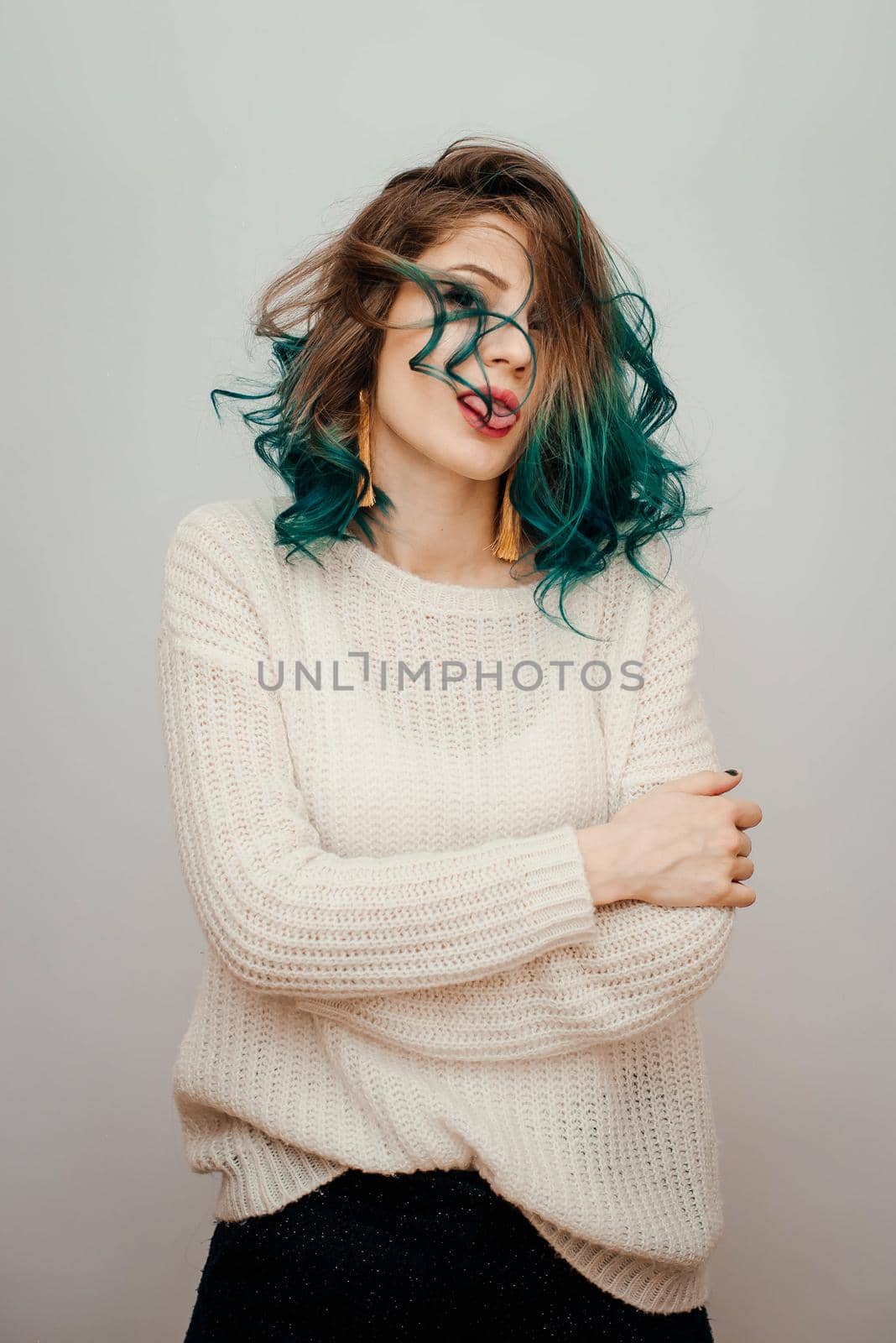 Happy woman with colored hair on a white background. Turquoise hair.