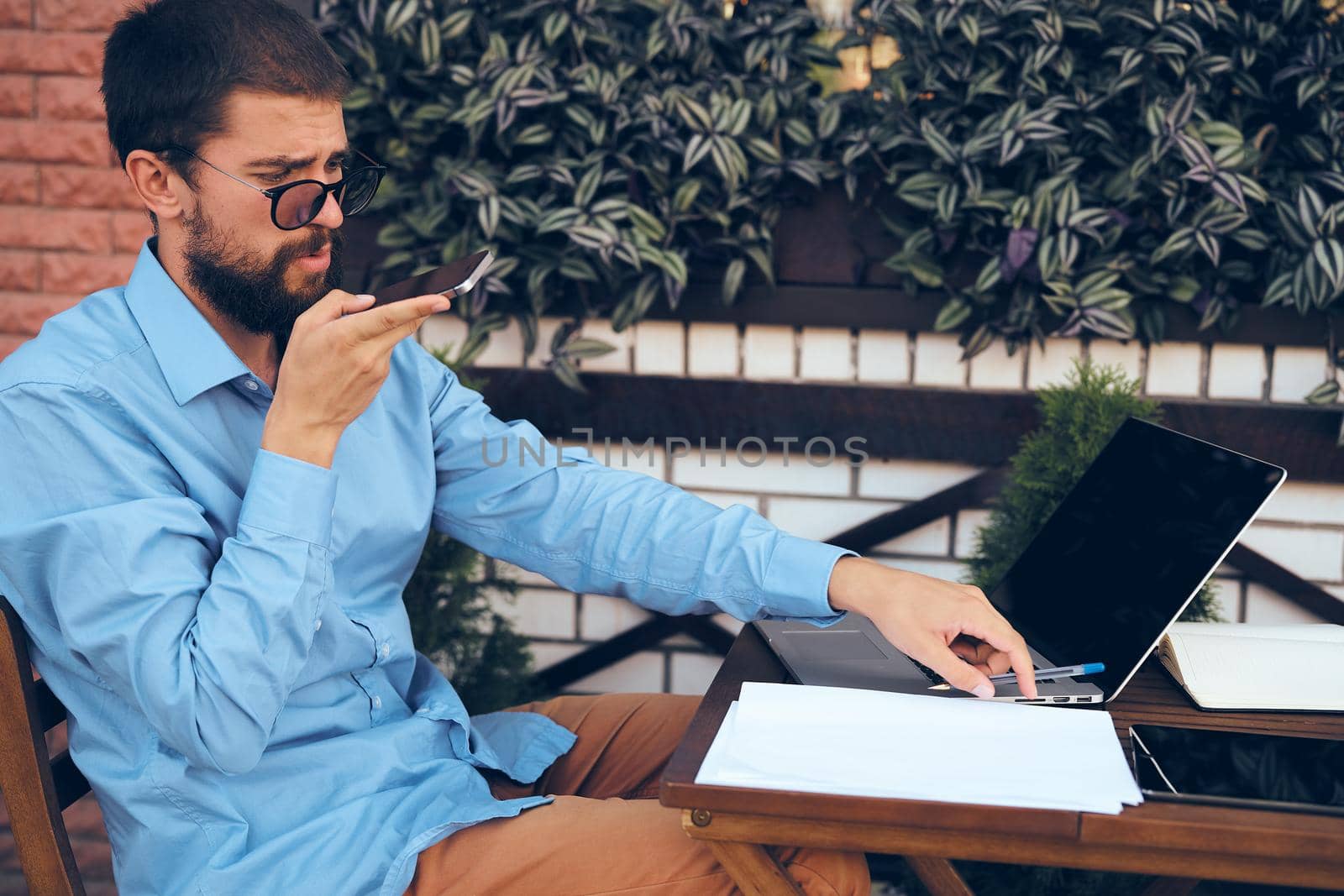 business man outdoors with laptop in cafe emotions. High quality photo