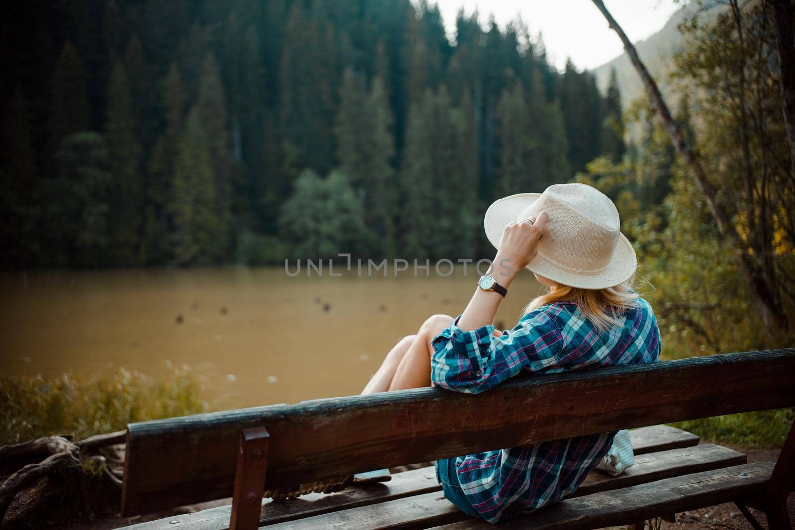 Young woman in a denim shirt and hat, by RecCameraStock