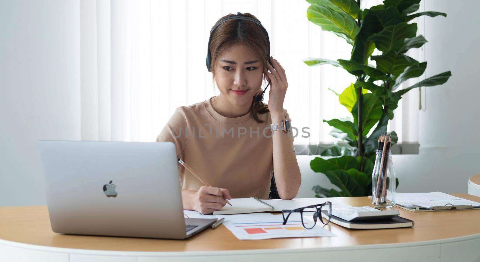 Close up Businesswoman using calculator and laptop for calaulating finance, tax, accounting, statistics and analytic research concept