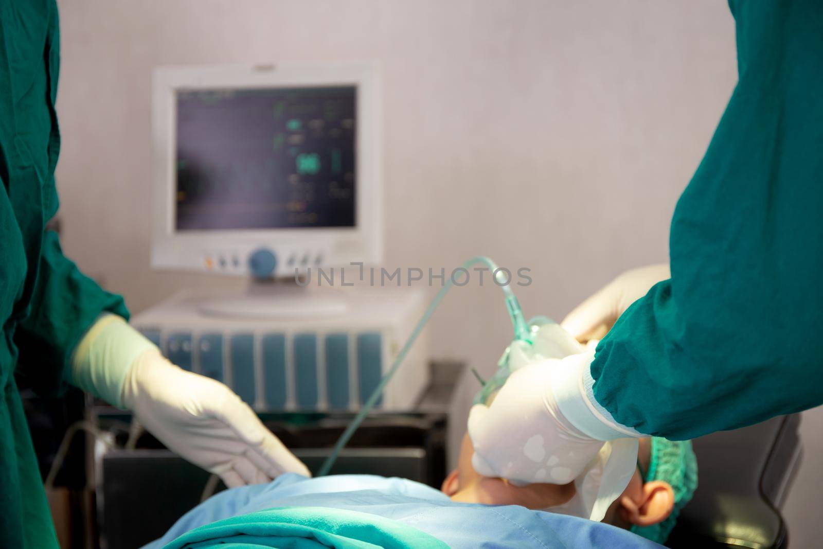 Closeup hands of doctor and assistant holding oxygen mask with patient emergency in the operation room at hospital, surgeon healing and surgery, problem of breathing, instruments medical and health. by nnudoo