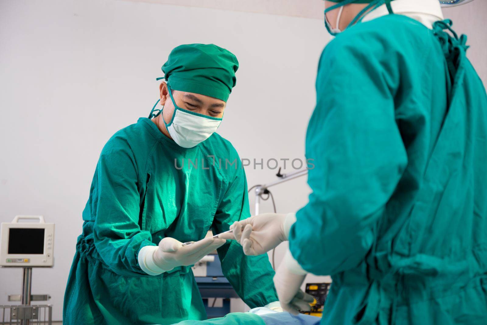 Doctor sending instrument with surgeon with rescue and  save patient in the operation room at hospital, surgery and emergency, medical and technology, surgical and health, specialist and assistant.