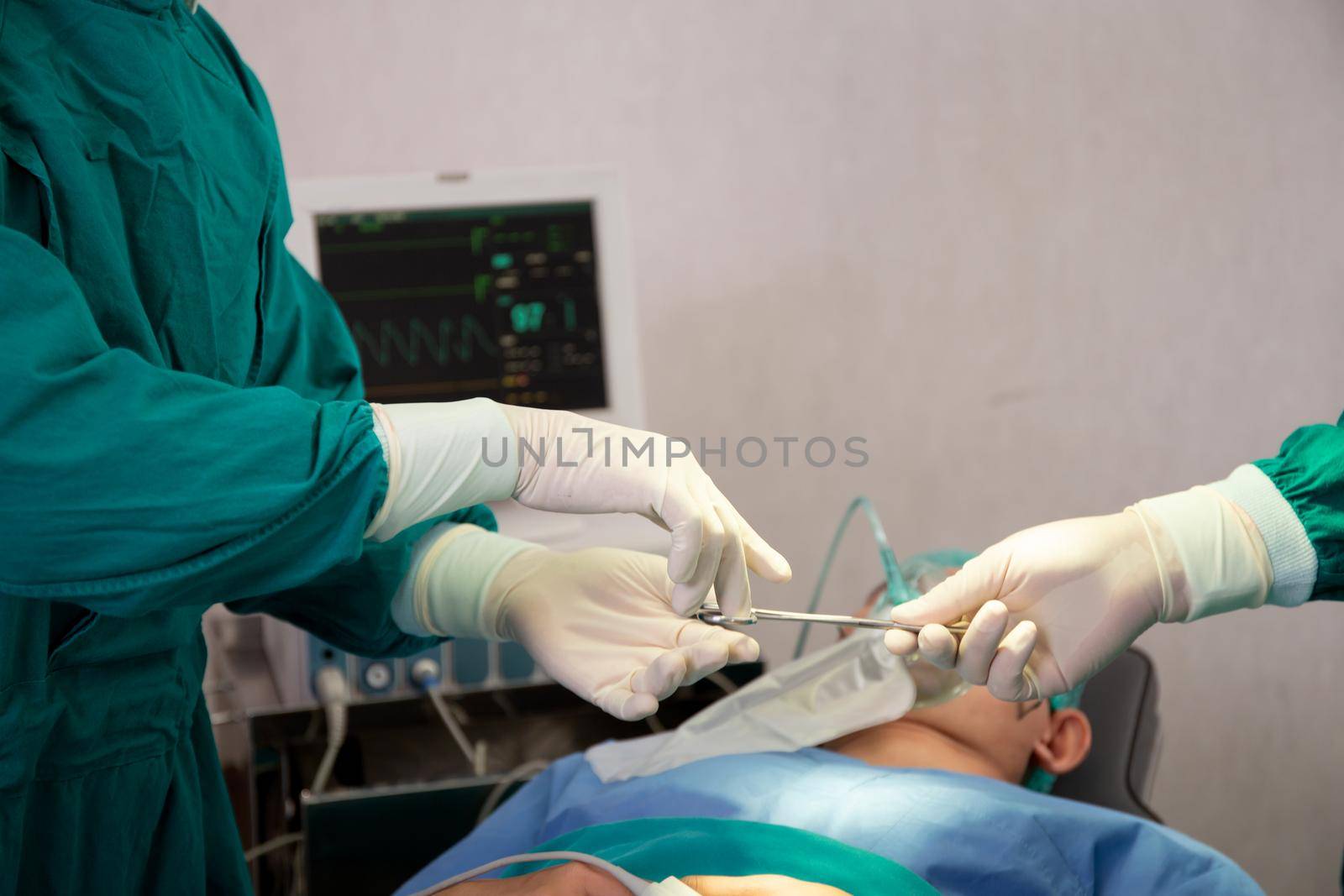 Closeup hands of doctor sending instrument with surgeon with rescue and  save patient in the operation room at hospital, surgery and emergency, medical and technology, specialist and assistant. by nnudoo