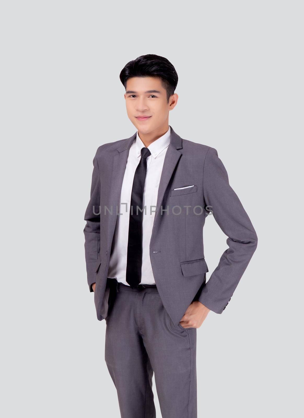 Portrait young asian businessman in suit with confident and friendly isolated on white background, business man smart with success hand in pocket, manager or executive with handsome and leadership. by nnudoo